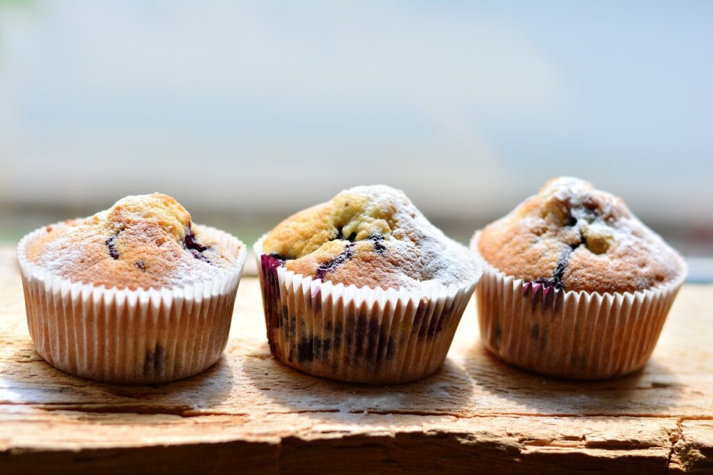 a group of muffins on a wood surface